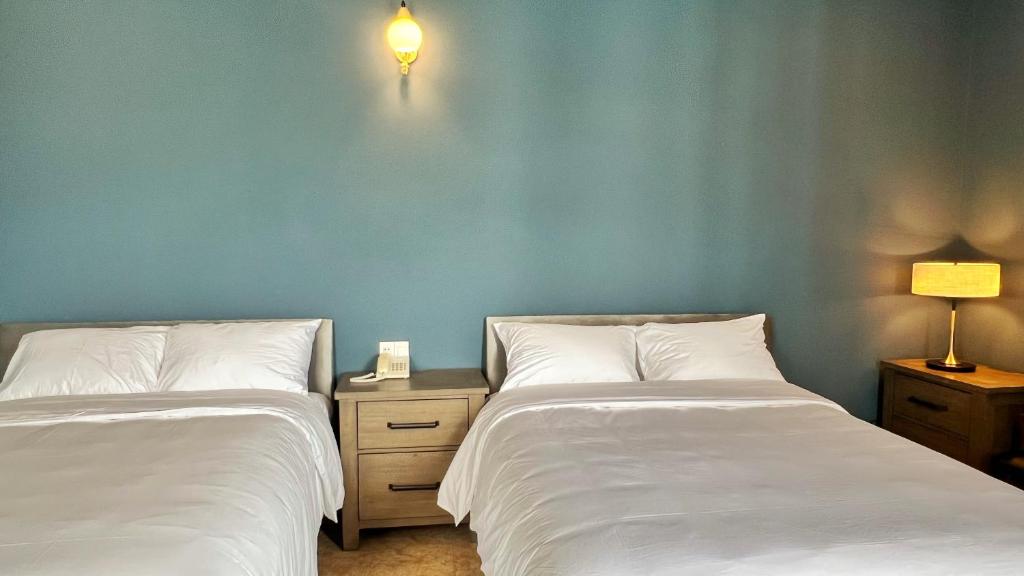 Postel nebo postele na pokoji v ubytování Khách Sạn Hưng Nguyên Valley ĐàLạt