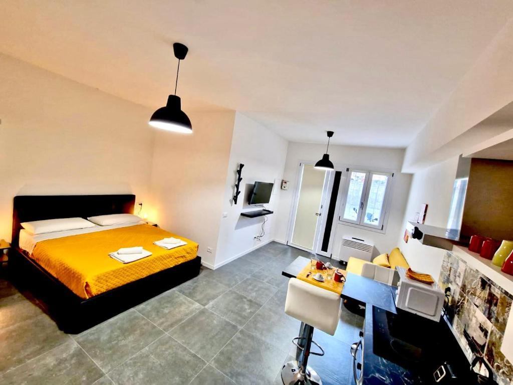 a bedroom with a yellow bed and a desk at FriendlyHouse in Bologna