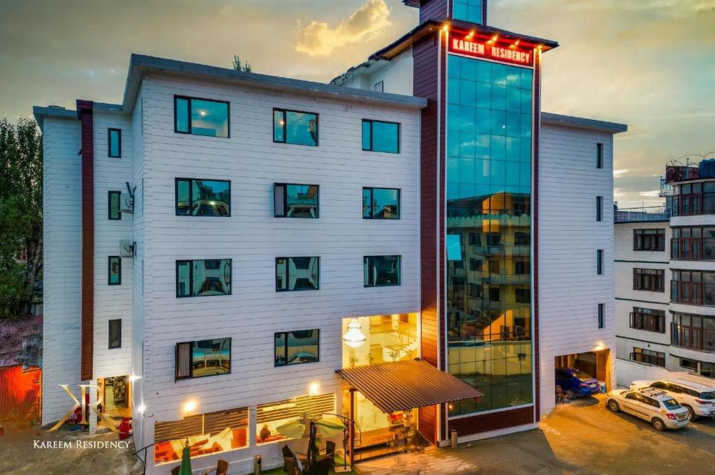 a large white building with a sign on it at KAREEM RESIDENCY in Srinagar