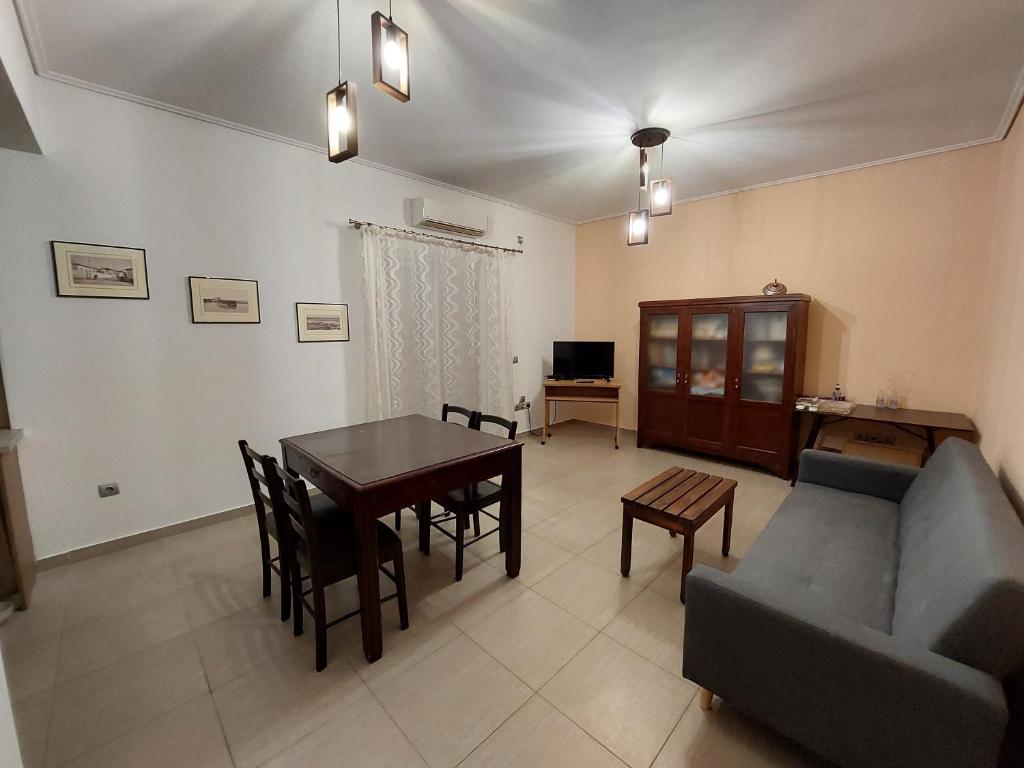 a living room with a table and a couch at SANTA MAURA in Lefkada Town