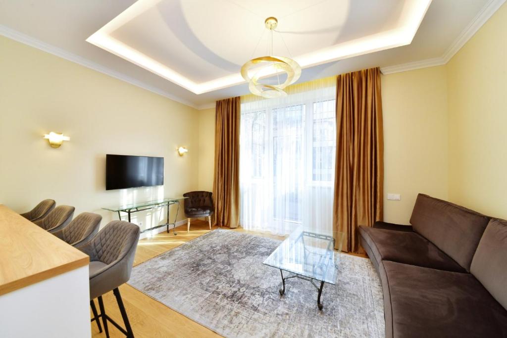 a living room with a couch and a table at Luxury Central Apartment in Putvinskio street in Kaunas