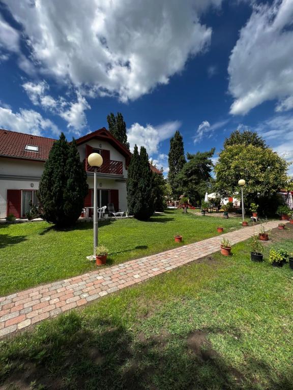 a brick path in front of a house at Zöld Zóna Zamárdi Üdülő in Zamárdi