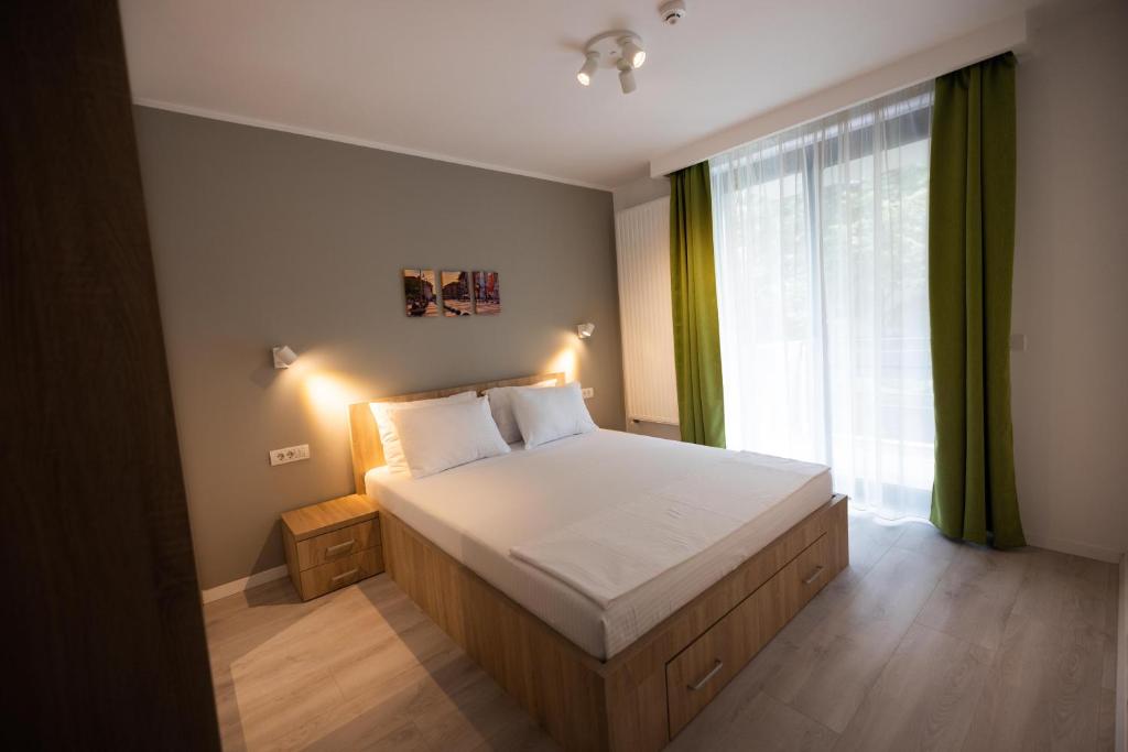 a bedroom with a bed and a large window at Timisoara Prime Residence in Timişoara