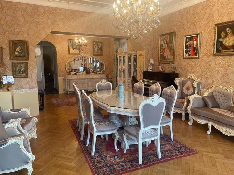 a living room with a table and chairs and a couch at hotel castle in Kutaisi