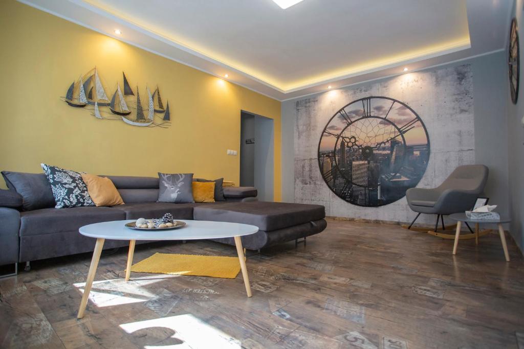 a living room with a couch and a table at Platán Apartman in Veszprém