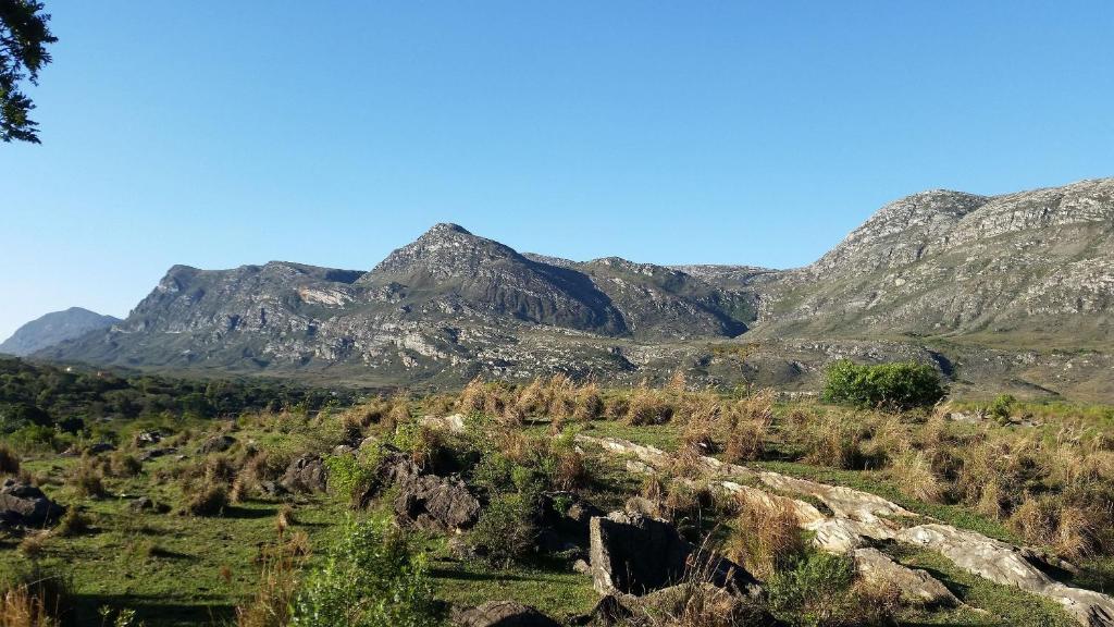 a view of a mountain range with trees and rocks at Casa do Vaz Lapinha da Serra in Santana do Riacho