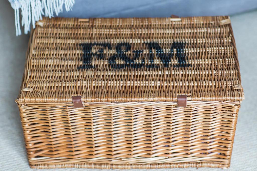 a wicker basket with the wordarma on it at Linden House in West Wittering