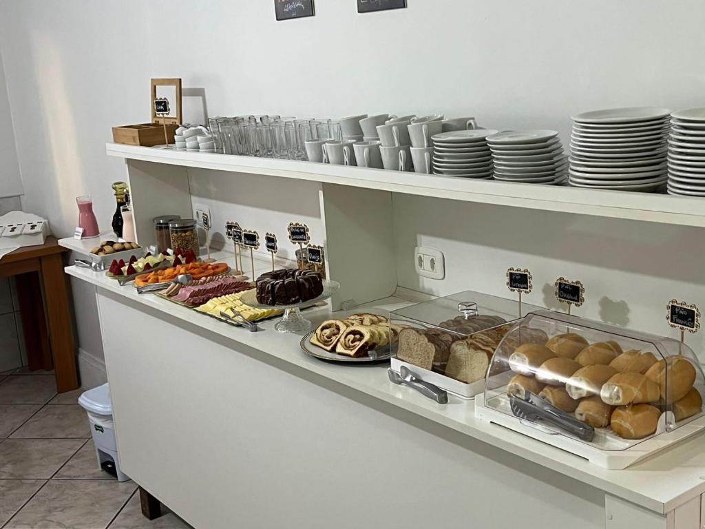 a shelf filled with lots of different types of food at Pousada Cinnamon in Canela