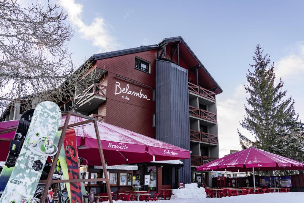 a snowboard is standing in front of a building at Hôtel Les 2 Alpes L'Orée Des Pistes in Les Deux Alpes