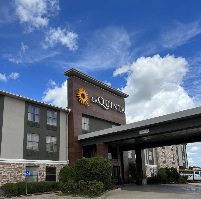 a building with a sun on the top of it at La Quinta by Wyndham Denison - North Lake Texoma in Denison