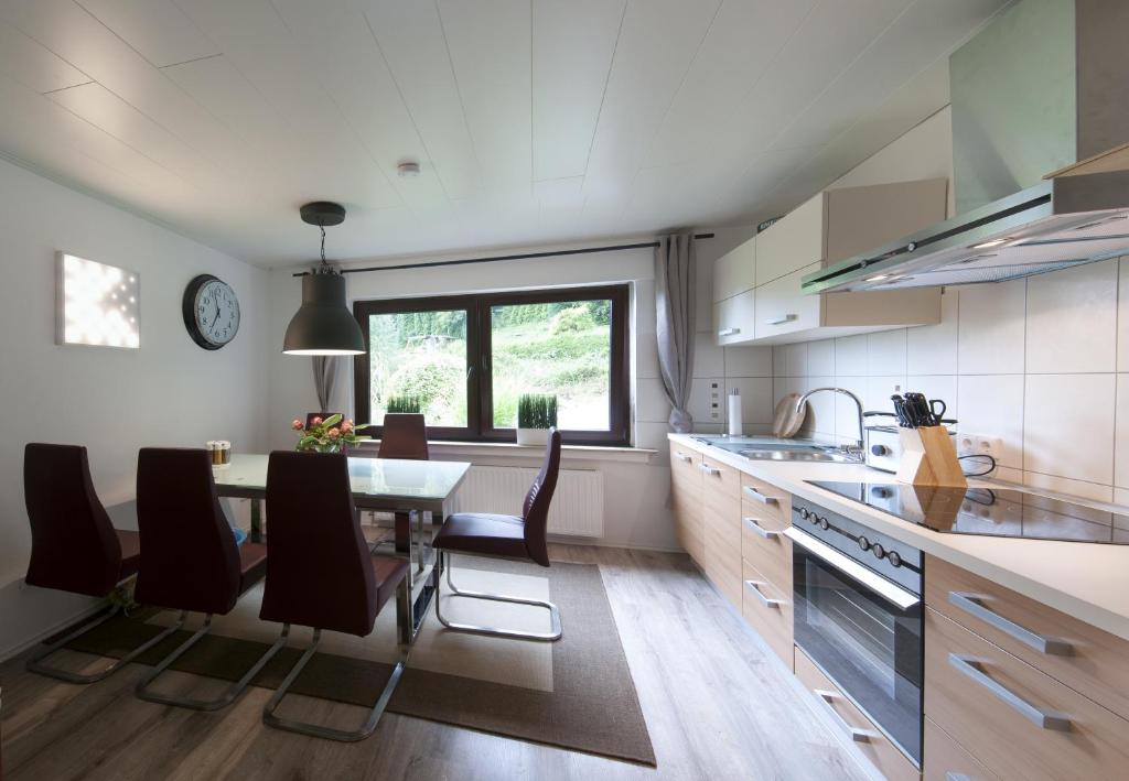 a kitchen with a table and chairs and a dining room at Pension-Werdohl in Werdohl