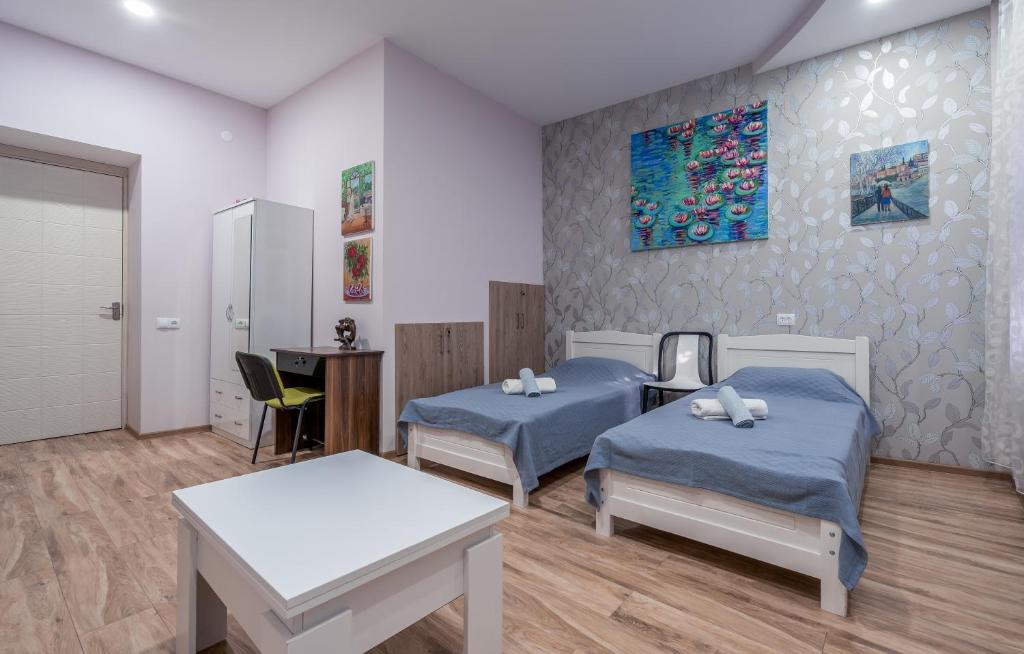 a hospital room with two beds and a table at Art-Gallery Avlabari in Tbilisi City
