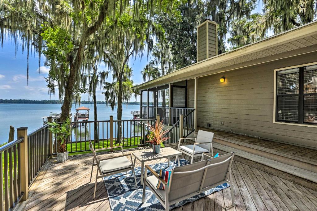 a house with a deck with chairs and a table at All Decked Out Home on Cherry Lake with Dock! in Madison