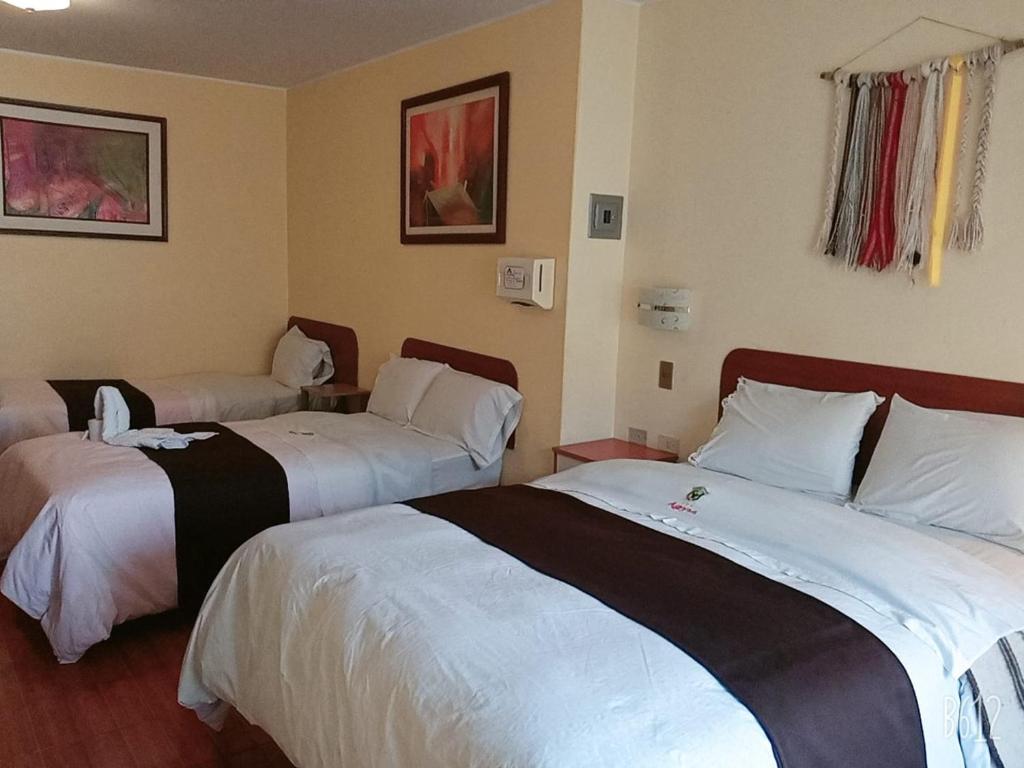 Cama o camas de una habitación en CasaHotel Centro - Huancayo