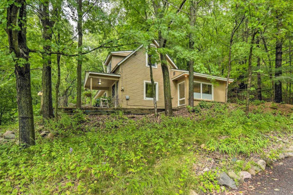 a small house in the woods with a driveway at St Croix Falls Remote Retreat Pet Friendly! in Saint Croix Falls
