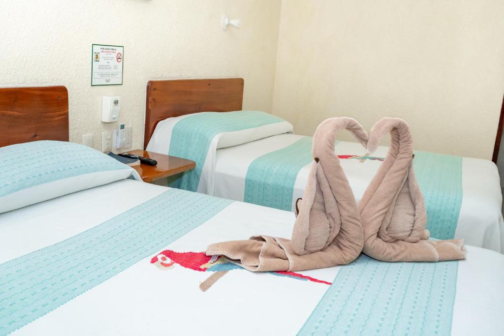 Postel nebo postele na pokoji v ubytování Hotel - Museo Xibalba