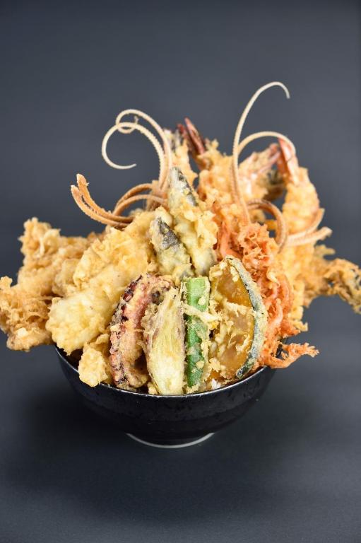 a bowl of food with a pile of seafood at Henn na Hotel New York in New York