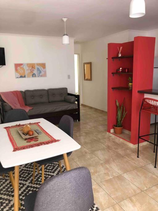 a living room with a couch and a table at Departamento moderno con balcon in Olavarría