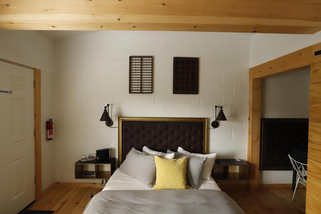 ein Schlafzimmer mit einem großen Bett mit gelben Kissen in der Unterkunft The vine on main in Stamford