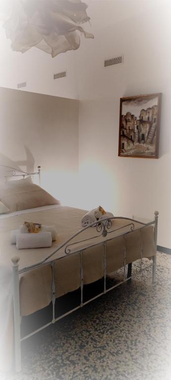 a bed in a white room with a ceiling at UltimoCasale in Matera
