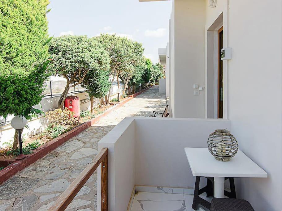 a white table sitting on the side of a building at Hersonissos Modern One Bedroom Apartment Beachside in Hersonissos