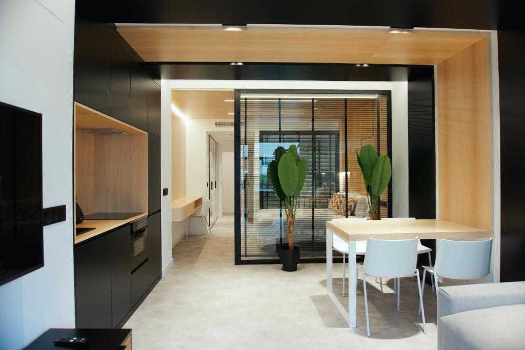 a kitchen and dining room with a table and chairs at Loft Mardevela in Sanxenxo