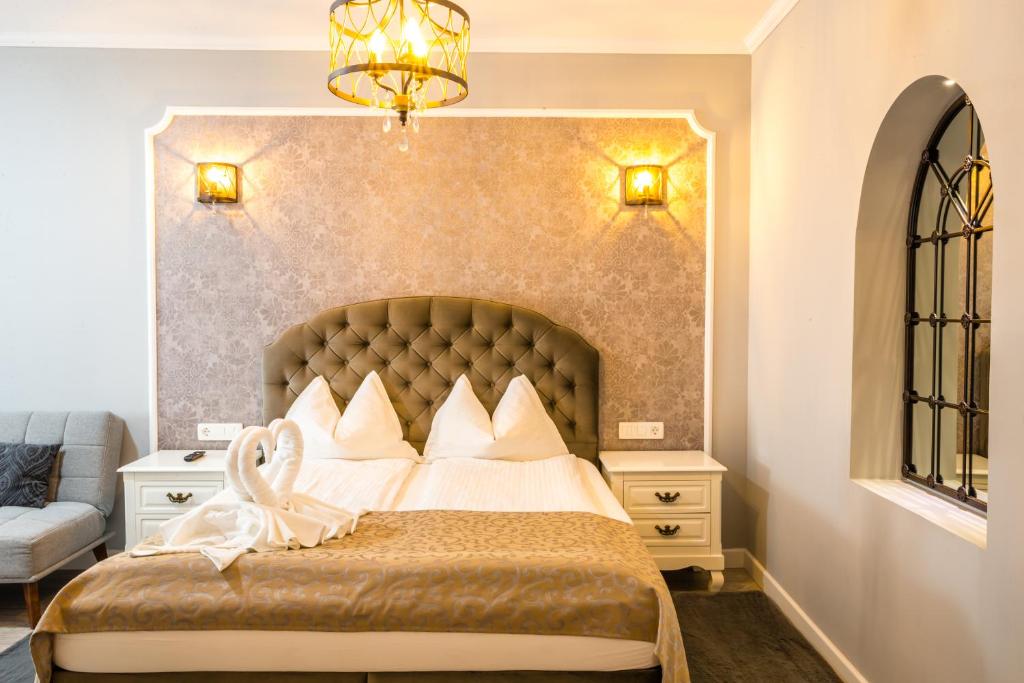 a bedroom with a large bed with white pillows at Casa Brainer in Sibiu