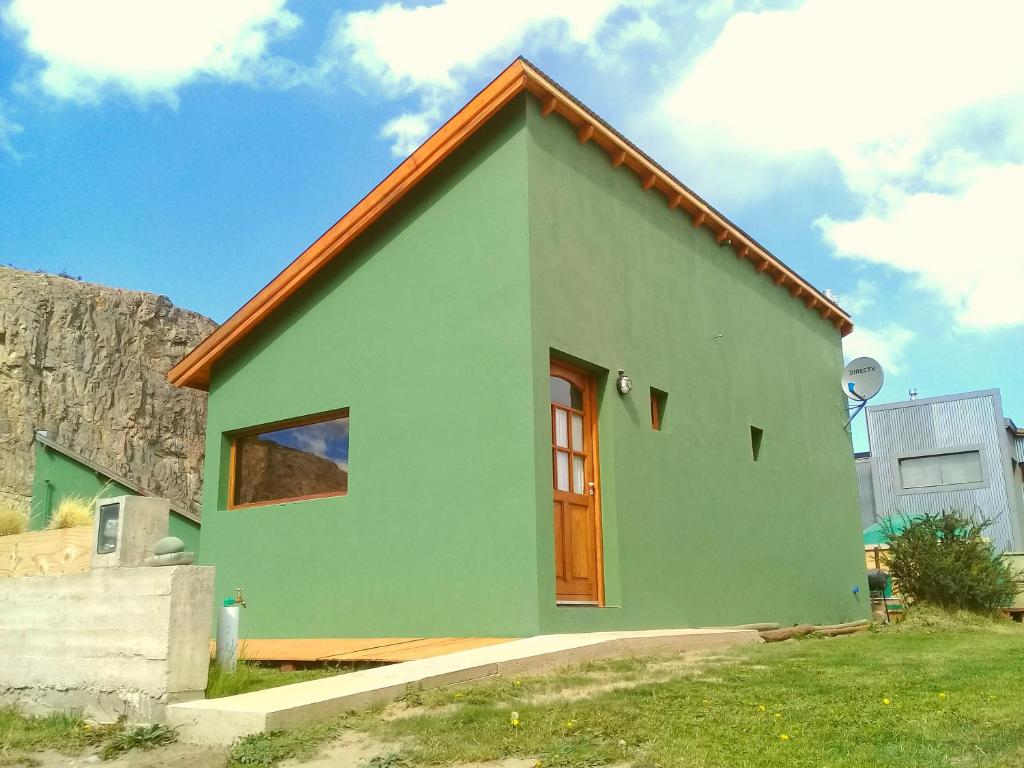 a small green house with a red roof at La Ribera - Saint Exupéry 90 in El Chalten