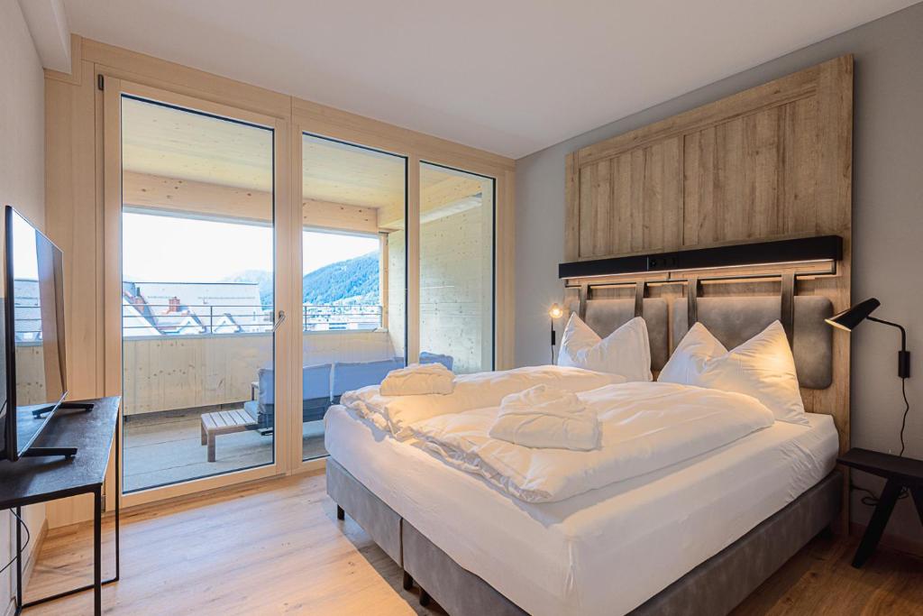 Ein Bett oder Betten in einem Zimmer der Unterkunft ALPINE INN Davos