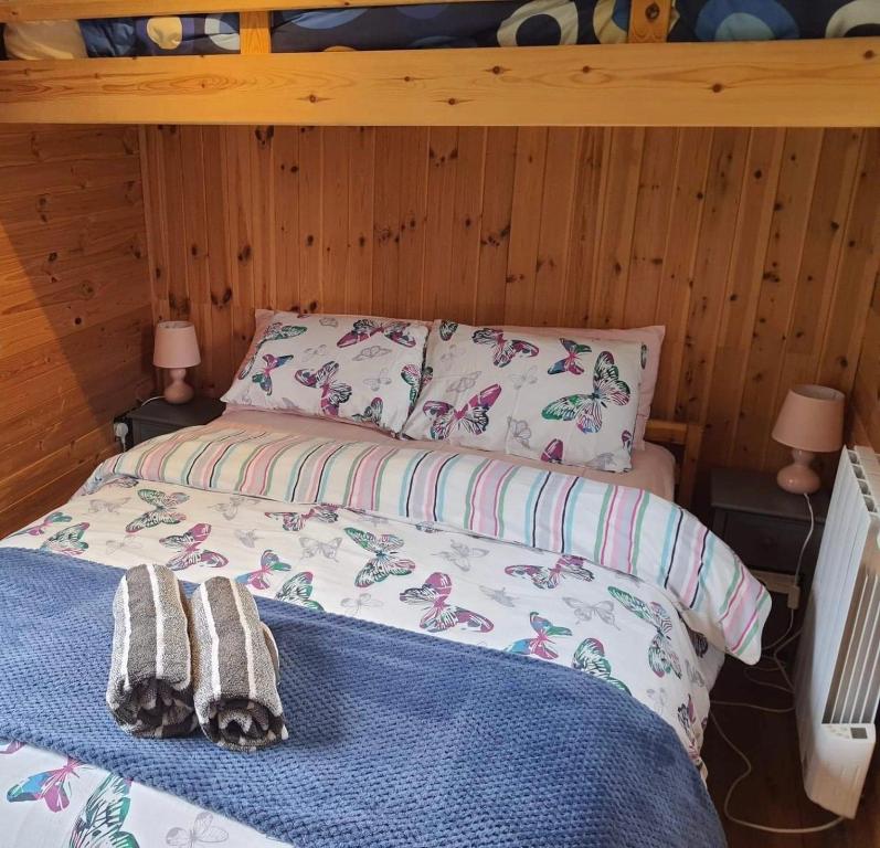 a bedroom with a bed with two towels on it at luxury railway carriage with stunning views in Hereford