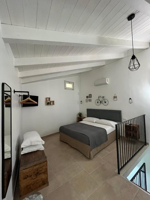 a bedroom with a bed in a white room at Zia Marietta Guest House in Altamura