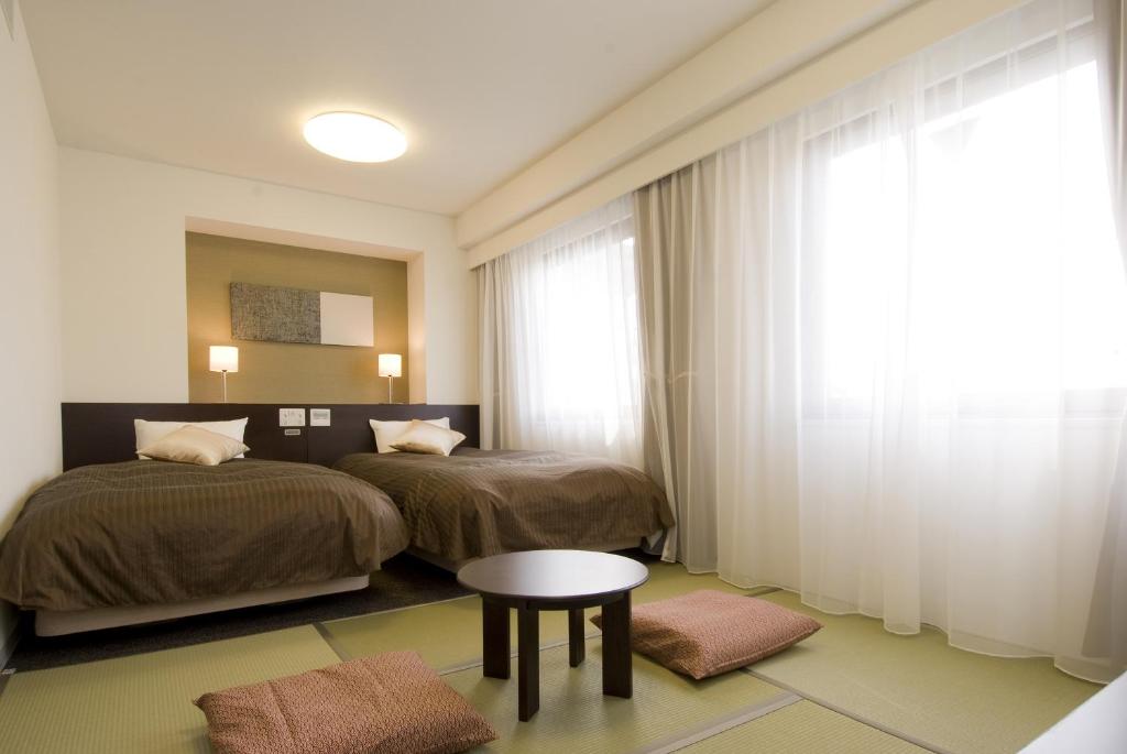 Ένα ή περισσότερα κρεβάτια σε δωμάτιο στο Dormy Inn Hakata Gion