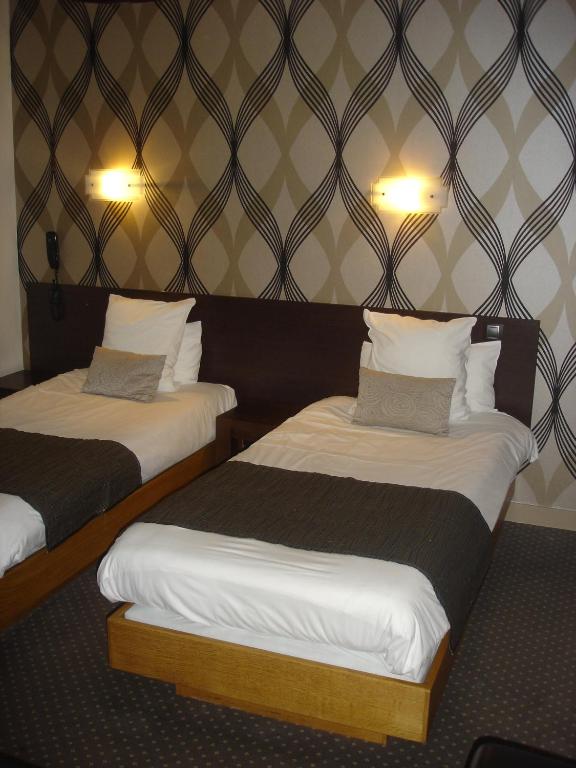 Postel nebo postele na pokoji v ubytování Hotel Reine Mathilde