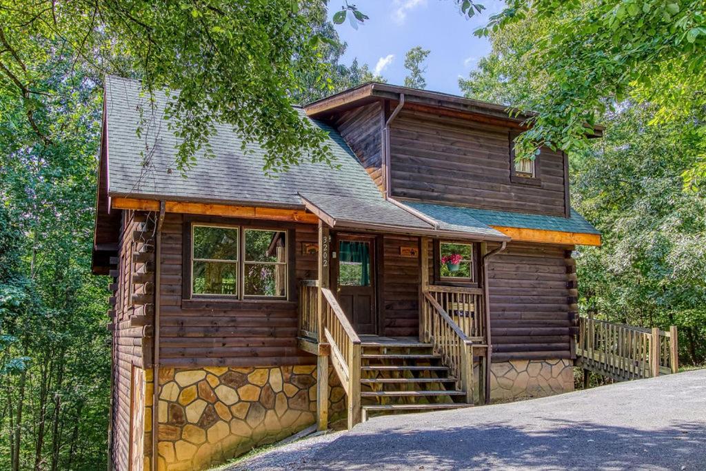 a log cabin with a staircase leading to the front door at Awesome Honey Bear- Get 951 worth of FREE area attraction tickets for each paid day!!! in Sevierville