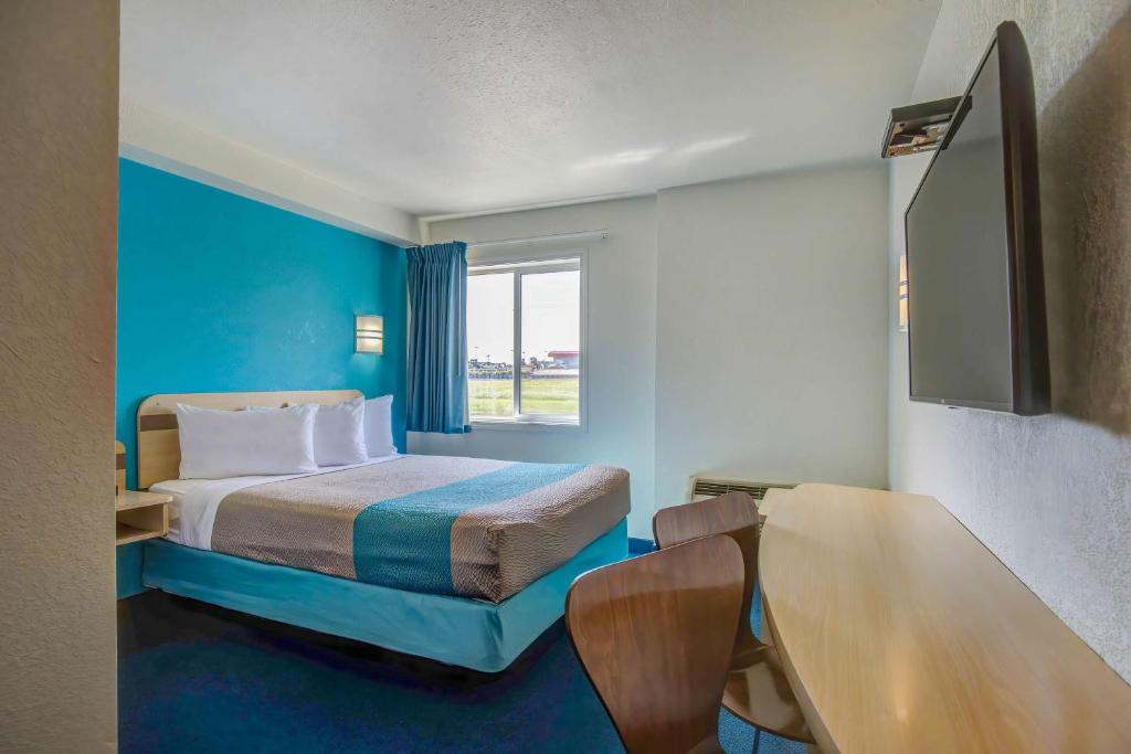 a hotel room with a bed and a window at Motel 6-Grande Prairie, AB in Grande Prairie