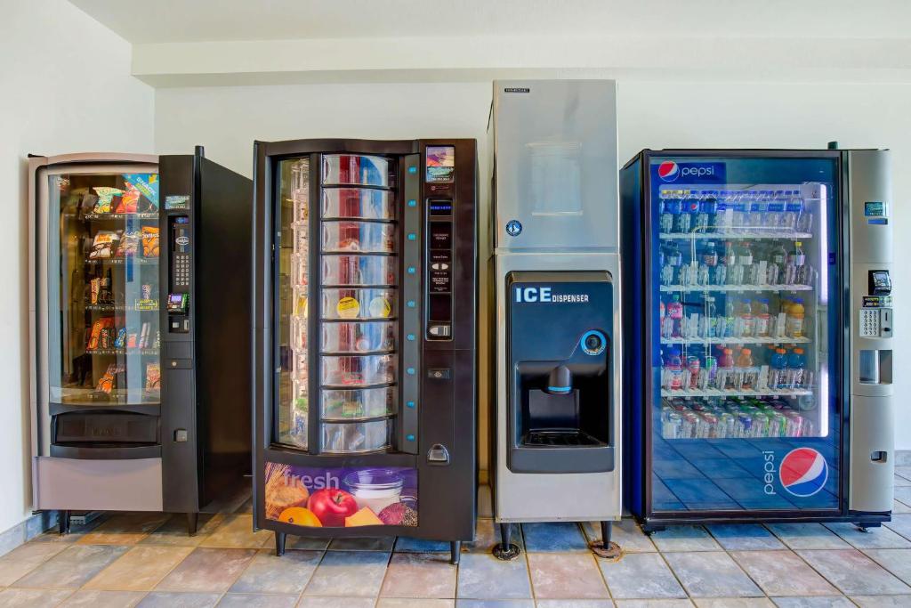 three vending machines are sitting next to each other at Motel 6-Grande Prairie, AB in Grande Prairie