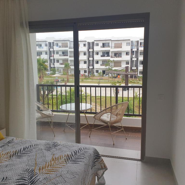 Postel nebo postele na pokoji v ubytování appartement haut standing en résidence Cabo Huerto vue sur deux grand Piscine