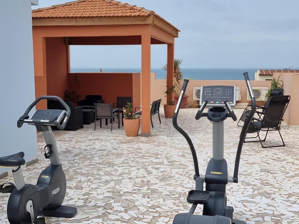 two exercise bikes parked next to a gazebo at SUPERBE APPARTEMENT MEUBLÉ AU BORD DE LA PLAGE in Mbaw