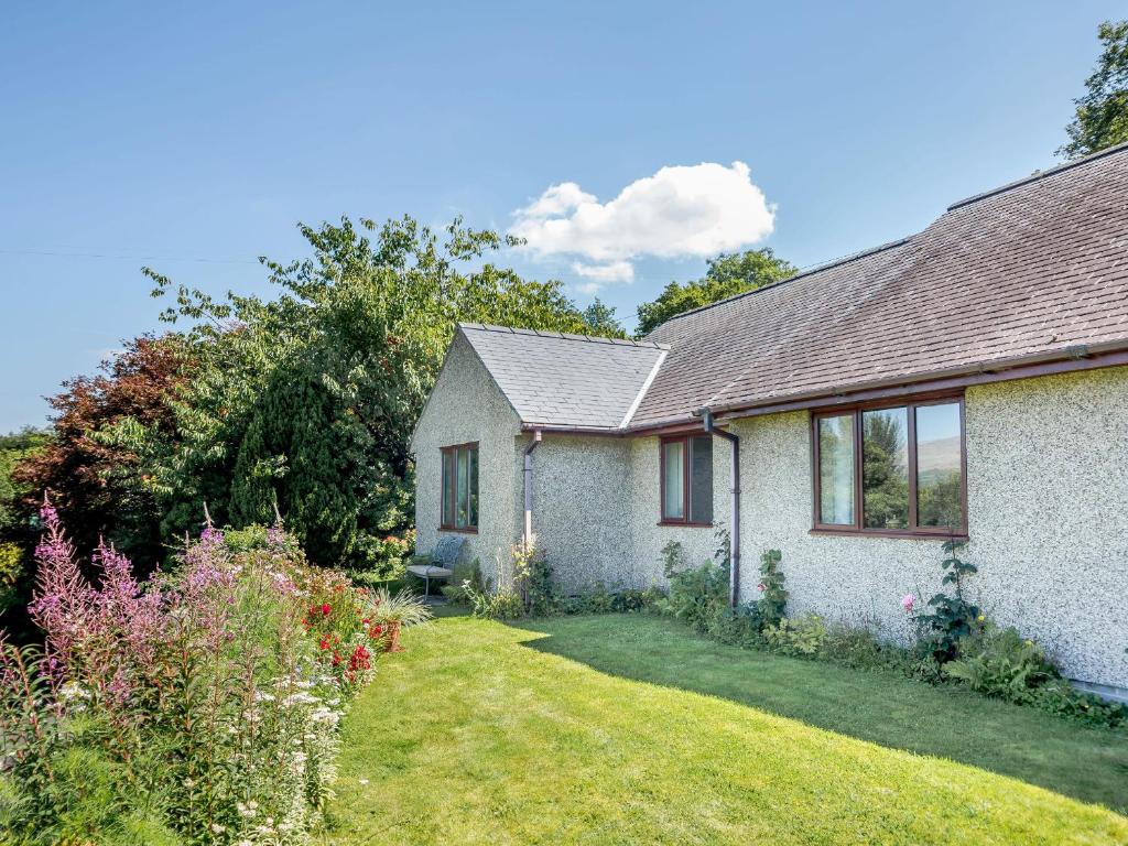 a house with a garden in front of it at Llety Nest in Llanfachreth