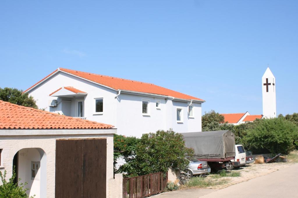 a white house with a truck parked in front of it at Apartment Mandre 6405b in Kolan