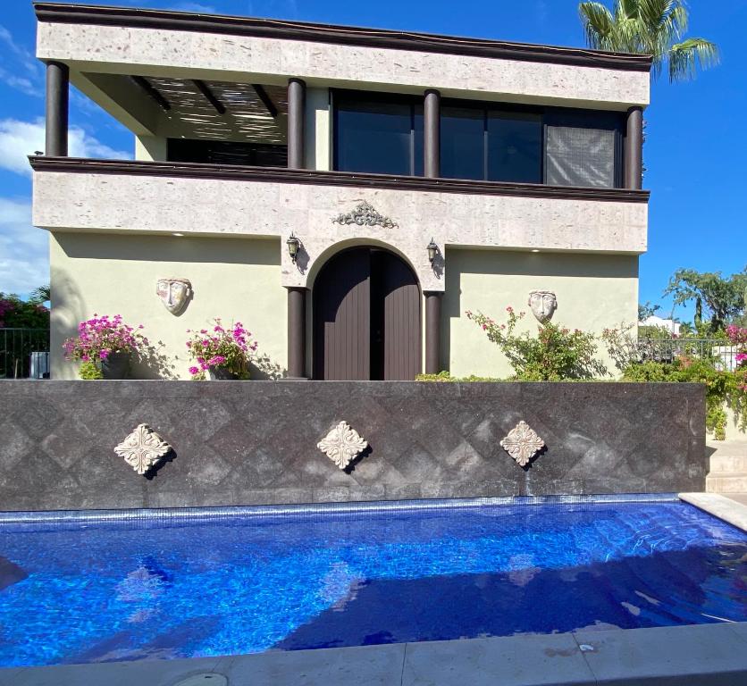 a house with a swimming pool in front of a house at Spectacular Vacation Home Ocean View Walk to Beach in Cabo San Lucas