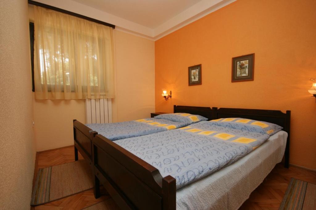 sypialnia z dużym łóżkiem i pomarańczowymi ścianami w obiekcie Apartments by the sea Umag - 7029 w mieście Umag
