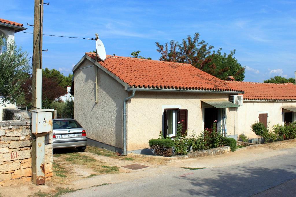a small white house with a red roof at Holiday house with a parking space Tar, Porec - 7025 in Tar