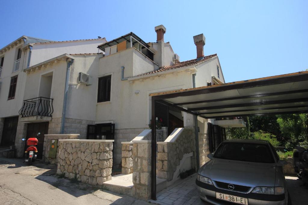 a car parked in front of a house at Apartments with WiFi Dubrovnik - 9073 in Dubrovnik