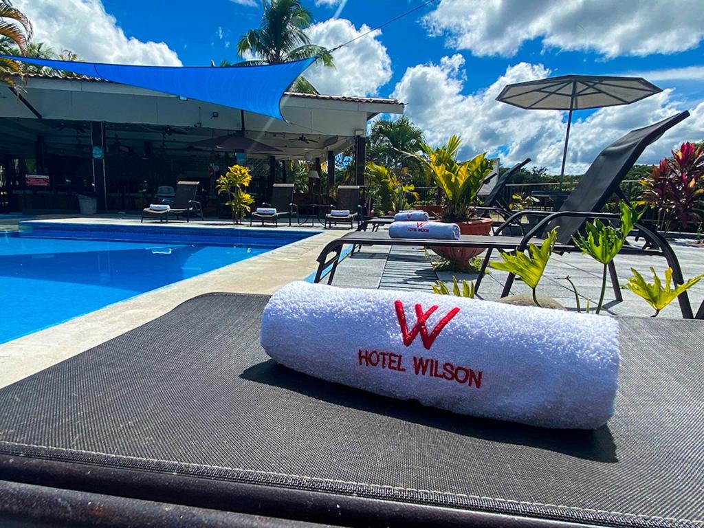 a hotel pillow sitting on a table next to a pool at Hotel El Regalo in Nicoya