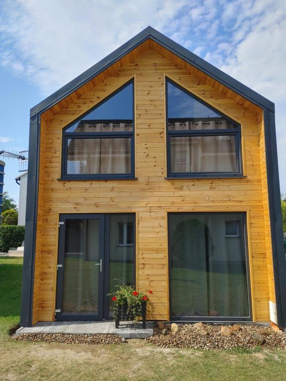 a house with large windows on the front of it at Domek u Antosia in Mechelinki