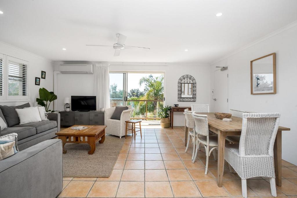 a living room with a couch and a table at Summer Salt in Byron Bay