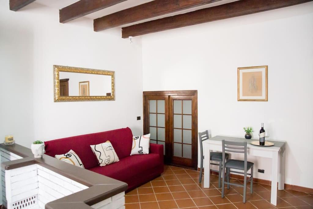 a living room with a red couch and a table at Casa Vacanze da Angela in Alghero