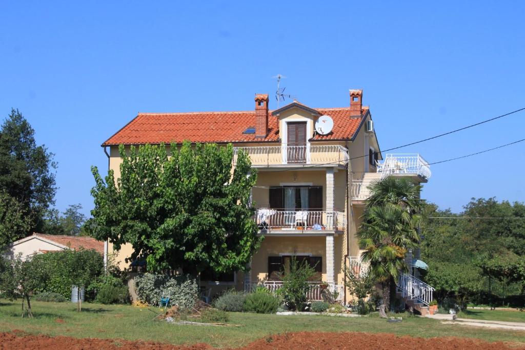 a large house with a clock on top of it at Apartment Basanija 7149b in Savudrija