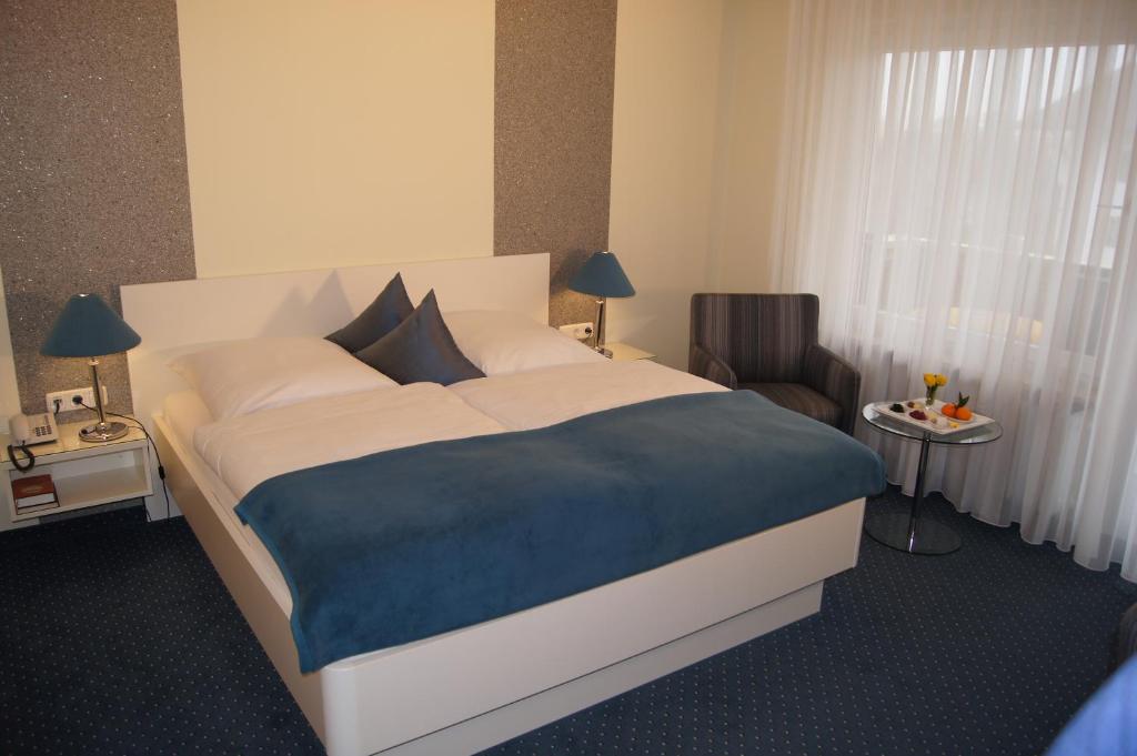 Postel nebo postele na pokoji v ubytování Hotel Christine